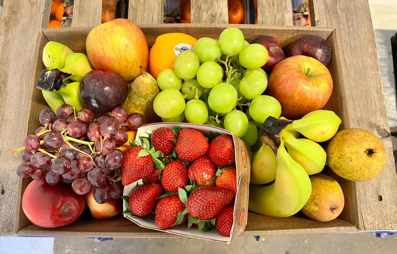 Beladener Sellerer-Lieferwagen mit Obstkisten